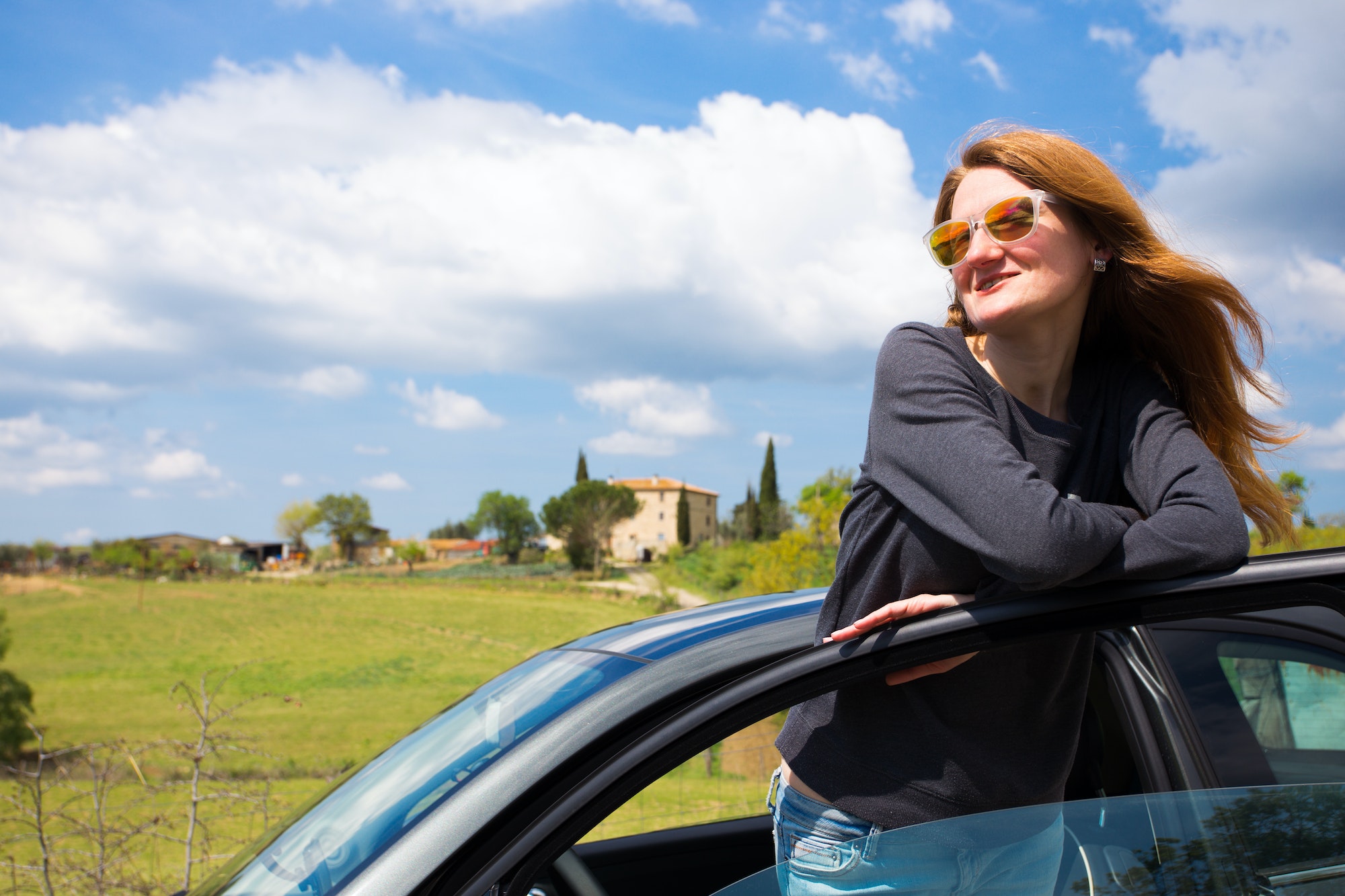 girl travelling by car in tuscany