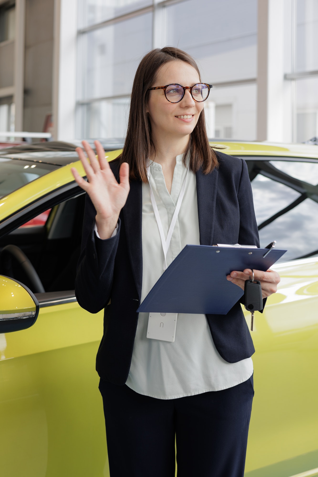 woman sells a car at a car dealership and hands over the keys to the buyer nice woman car sales 1